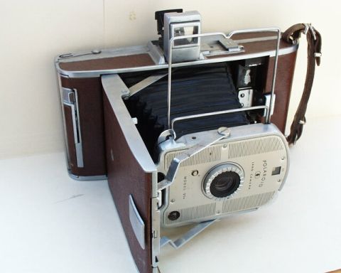 1973 Ford Ranchero - Polaroid Land Camera Model 95, a vintage folding camera with a brown leatherette finish and chrome accents.
