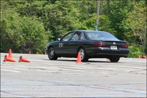 2001 Mercury Grand Marquis - Black sedan with number 251 on door navigates a course marked by orange cones.