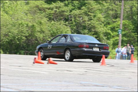 2001 Mercury Grand Marquis - A black sedan, likely a Chevrolet Impala, competes in an autocross event, marked with the number 251.