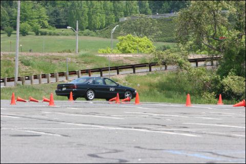 2001 Mercury Grand Marquis - A black sedan with the number 251 on its door navigates an autocross course marked by orange cones.