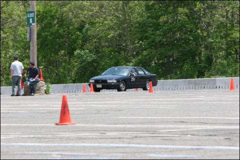 2001 Mercury Grand Marquis - A black sedan is seen on an autocross course, marked with cones and the number 251.