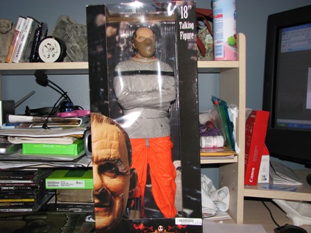 1991 Ford Bronco - An 18-inch talking figure, dressed in a straitjacket and orange pants, is displayed in its packaging.