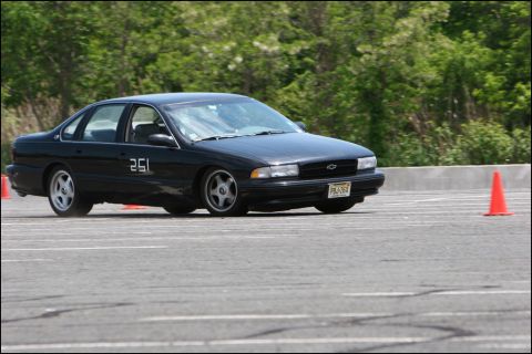 2001 Mercury Grand Marquis - A black Chevrolet sedan, likely a 1994 Impala SS, navigates an autocross course with racing number 251 visible on its door.