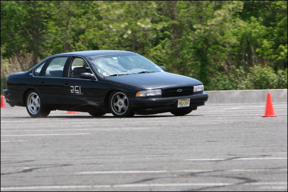 Black Chevrolet sedan with racing number 251 on door, seen from 3/4 front