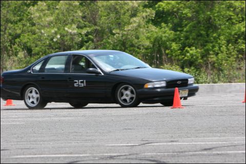 2001 Mercury Grand Marquis - Black Chevrolet Impala SS navigates an autocross course marked by orange cones.