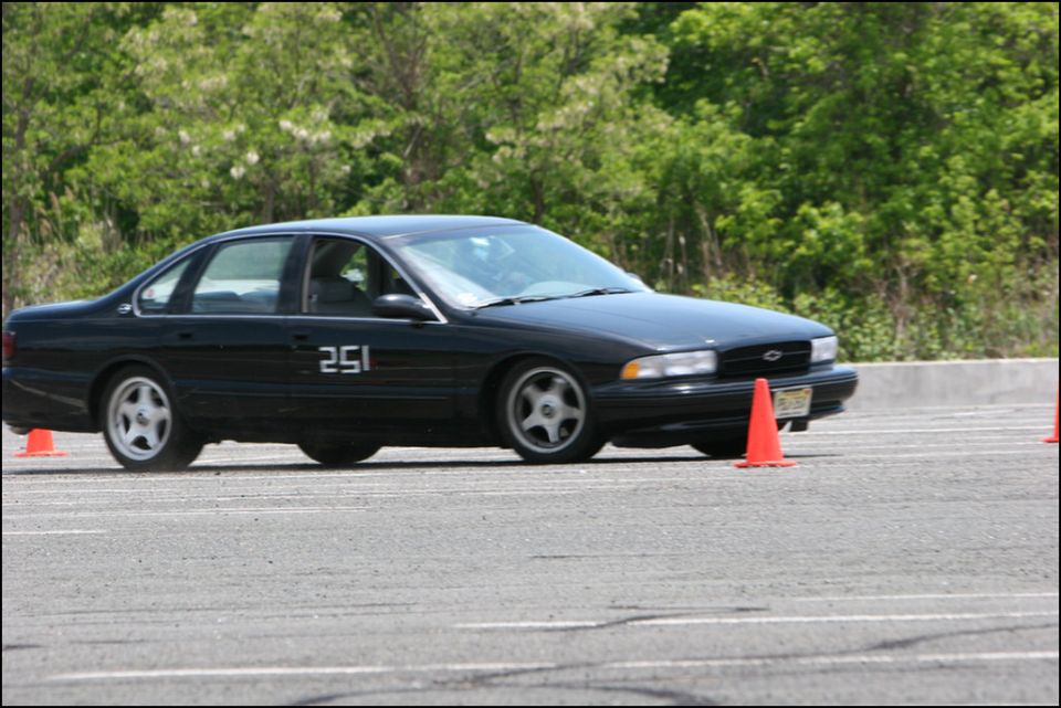 Black Chevrolet Impala SS with number 251 on the door, driving on a track with orange cones
