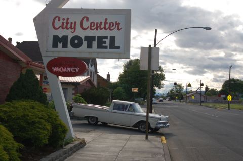 1967 Ford Ranchero - A 1959 Ford Ranchero is parked by the City Center Motel sign on a cloudy day.