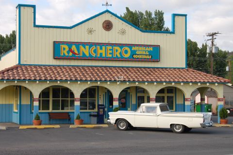 1967 Ford Ranchero - A white 1959 Ford Ranchero pickup truck is parked outside a building with a "Ranchero Mexican Grill Cocktails" sign.