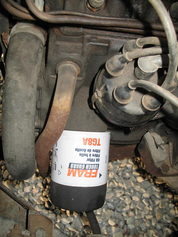 FRAM Tough Guard TG8A oil filter on engine underside near distributor cap and plug wires