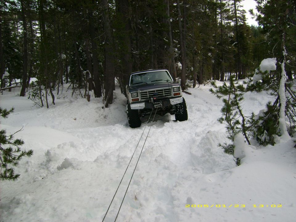 Dark blue 1980s Ford Bronco with winch in snow