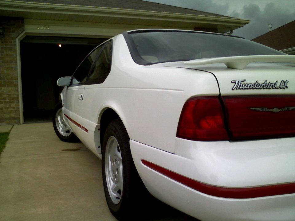 White 1995 Ford Thunderbird LX coupe, rear quarter view, parked in driveway