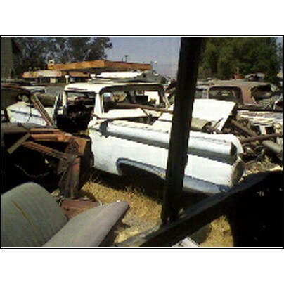 1973 Ford Ranchero - Multiple old pickup trucks are visible in a junkyard setting.