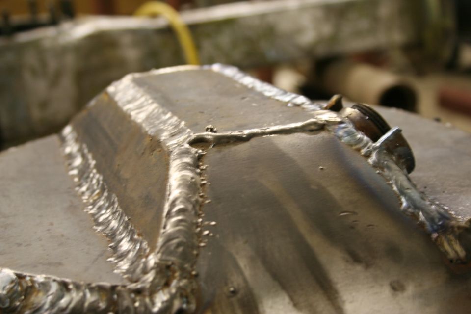 Drain Plug. Most people don't do this, I guess because they just lose enough of the fluid through the sides axle shaft seals, but I figured I wanted one to clean the housing out from any debris via a flush. So i made one. Take note of the world class welds. I ground them down.

Update: Originally the plug leaked from a pinhole inside the shield from the plasma cutter when I took it out of the old housing. I'd recommend double plating a spot, then drilling a hole though both, then taping it for a 3/4" NPT.