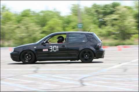 2001 Mercury Grand Marquis - A black Volkswagen GTI competes in an autocross event, displaying the number 301.
