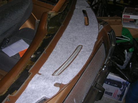 1975 Ford Ranchero - A close-up view of a vehicle's dashboard panel being fitted with new carpet padding.