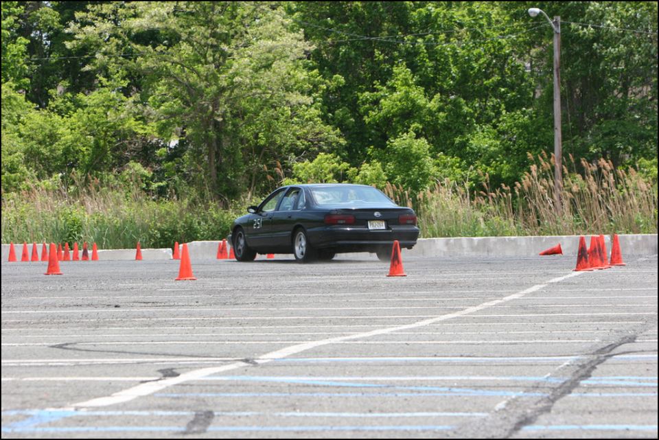 Black sedan with number 25 on door navigates autocross course