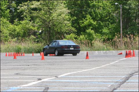 2001 Mercury Grand Marquis - A 2001 Mercury Grand Marquis navigates an autocross course marked by orange cones.