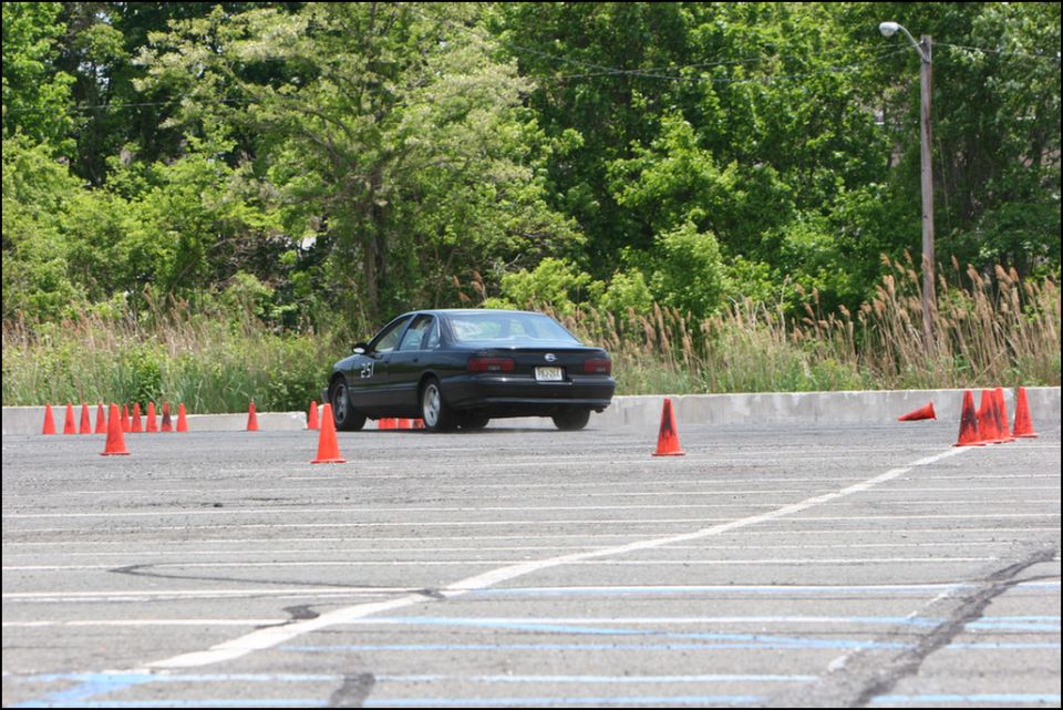 2001 Mercury Grand Marquis on a race track with orange cones, rear view
