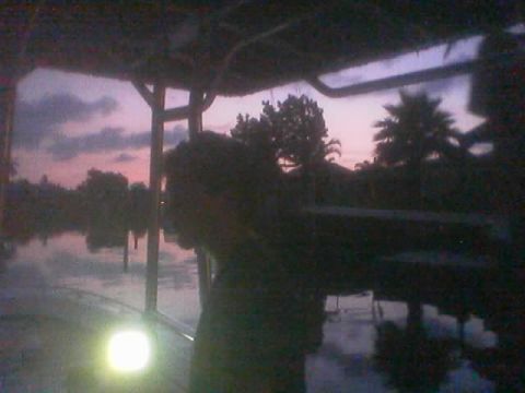 1989 Ford Bronco - A person is silhouetted against a colorful twilight sky reflected in the water.