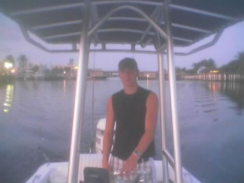 1989 Ford Bronco - Person at the helm of a boat navigating a canal at dusk.