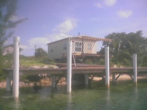 1989 Ford Bronco - A house on stilts is visible from a pier extending over the water.