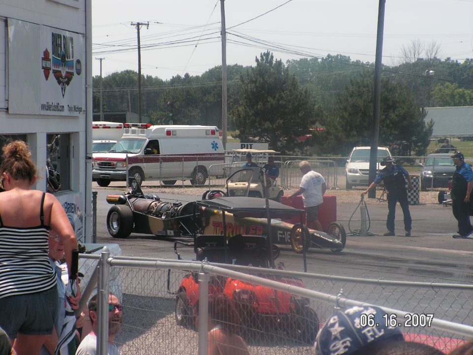 Dragster with jet engine and a golf cart on a race track