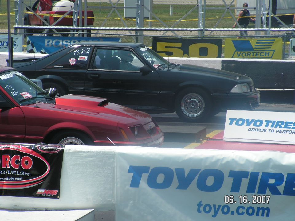 Black 1988 Ford Mustang coupe drag car on track