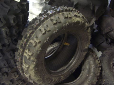 1974 Ford Bronco - A close-up view of several off-road tires stacked together, with one tire prominently displayed in the foreground.