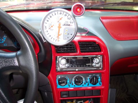 1994 Ford Probe - Customized car interior a large tachometer and aftermarket stereo system.