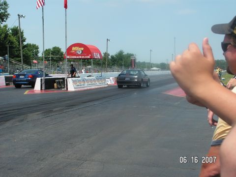 1988 Ford Mustang - Two Ford Mustangs compete at Milan Dragway on a sunny day.