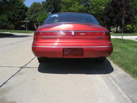 1996 Lincoln Mark VIII - Rear view of a red 1996 Lincoln Mark VIII parked on a driveway.
