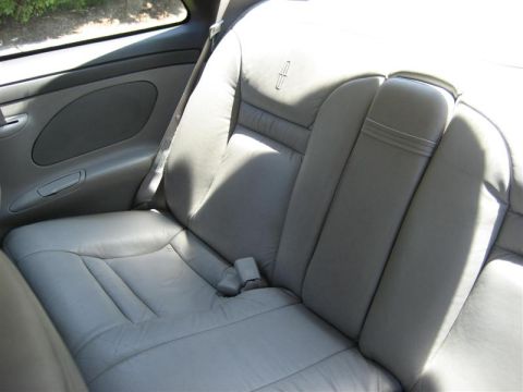 1996 Lincoln Mark VIII - Interior view of the rear leather seats and door panel of a 1996 Lincoln Mark VIII.