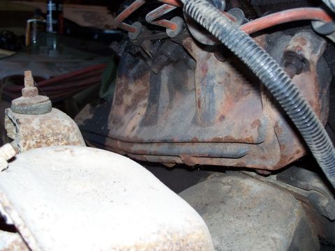 1979 Ford F-150 - This image shows a close-up view of a heavily rusted engine exhaust manifold and associated components.