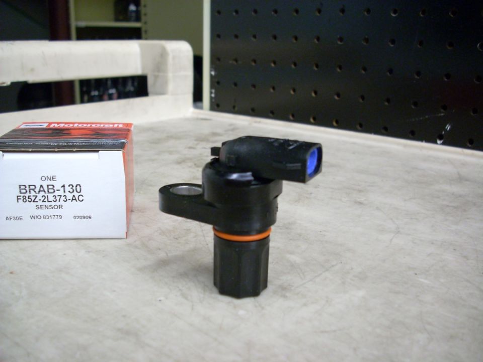 Motorcraft BRAB-130 ABS sensor F85Z-2L373-AC standing beside its box on a bench
