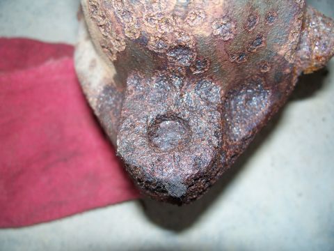 1979 Ford F-150 - This close-up shows significant rust and corrosion on a vehicle exhaust component.