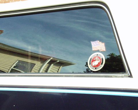 1989 Ford Bronco - A vehicle window displays stickers for the US flag and the United States Marine Corps.