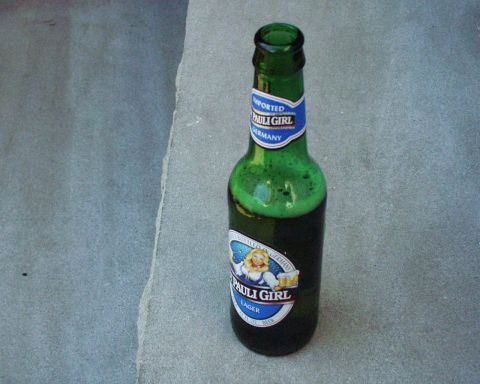 1989 Ford Bronco - A bottle of Pauli Girl beer is shown on a textured surface.