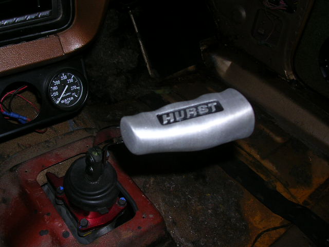 Hurst shifter and water temperature gauge inside vehicle