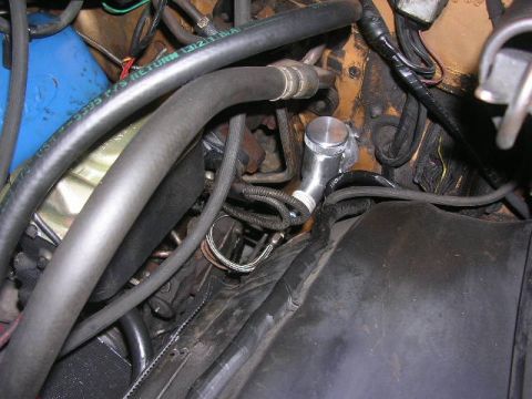 1975 Ford Ranchero - Engine bay components including hoses and a custom reservoir are visible in this close-up shot.