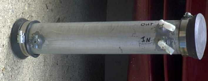 Homemade clear-tube oil catch can with hose barbs marked IN and OUT