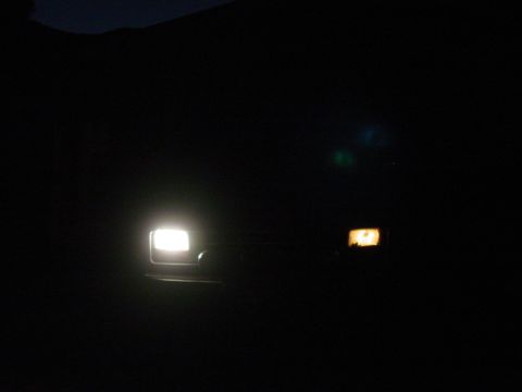1994 Ford Bronco - Front view of a 1994 Ford Bronco's headlights and marker lights on at night.