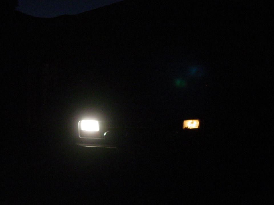 1994 Ford Bronco front lights illuminated at night