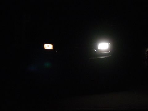 1994 Ford Bronco - The photo shows the front of a vehicle at night, with its headlights on.
