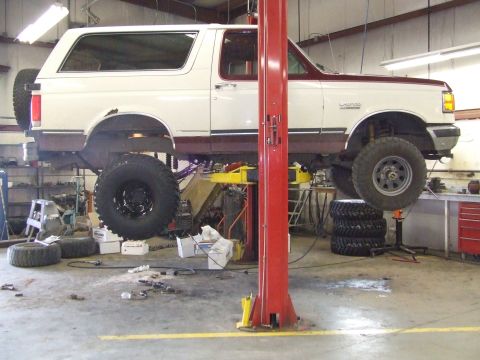 1990 Ford Bronco - This 1990 Ford Bronco is raised on a lift for maintenance in a workshop setting.