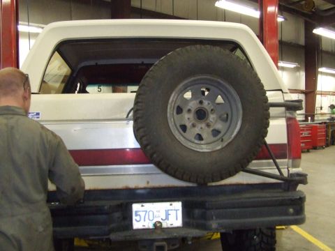 1990 Ford Bronco - Rear view of a 1990 Ford Bronco with a spare tire on the tailgate and a license plate.