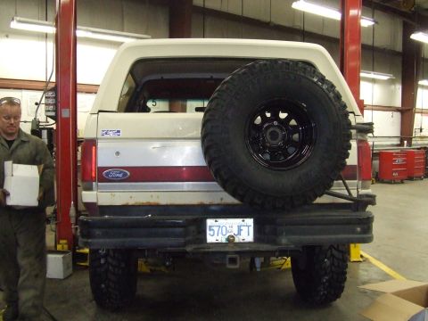 1990 Ford Bronco - The rear of a Ford Bronco is shown, a spare tire and a license plate reading '570 JFT'.