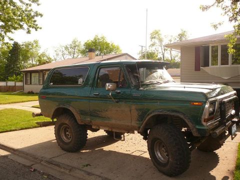 1978 Ford Bronco - This lifted 1978 Ford Bronco is parked on a driveway in front of a house.