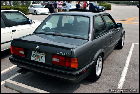 1989 BMW 3 Series - Rear view of a dark gray 1989 BMW 325i sedan with a spoiler and aftermarket wheels.