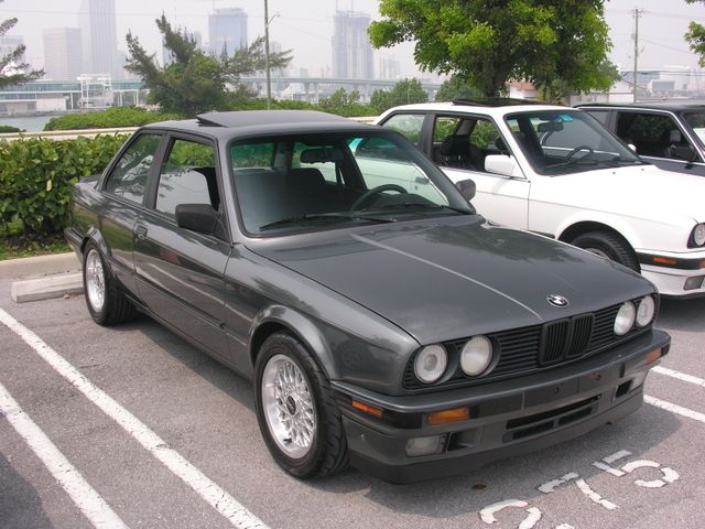 Dark gray 1989 BMW 3 Series coupe parked next to a white BMW