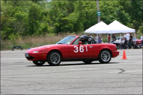 2001 Mercury Grand Marquis - A red convertible sports car with racing number 361 participates in an autocross event.